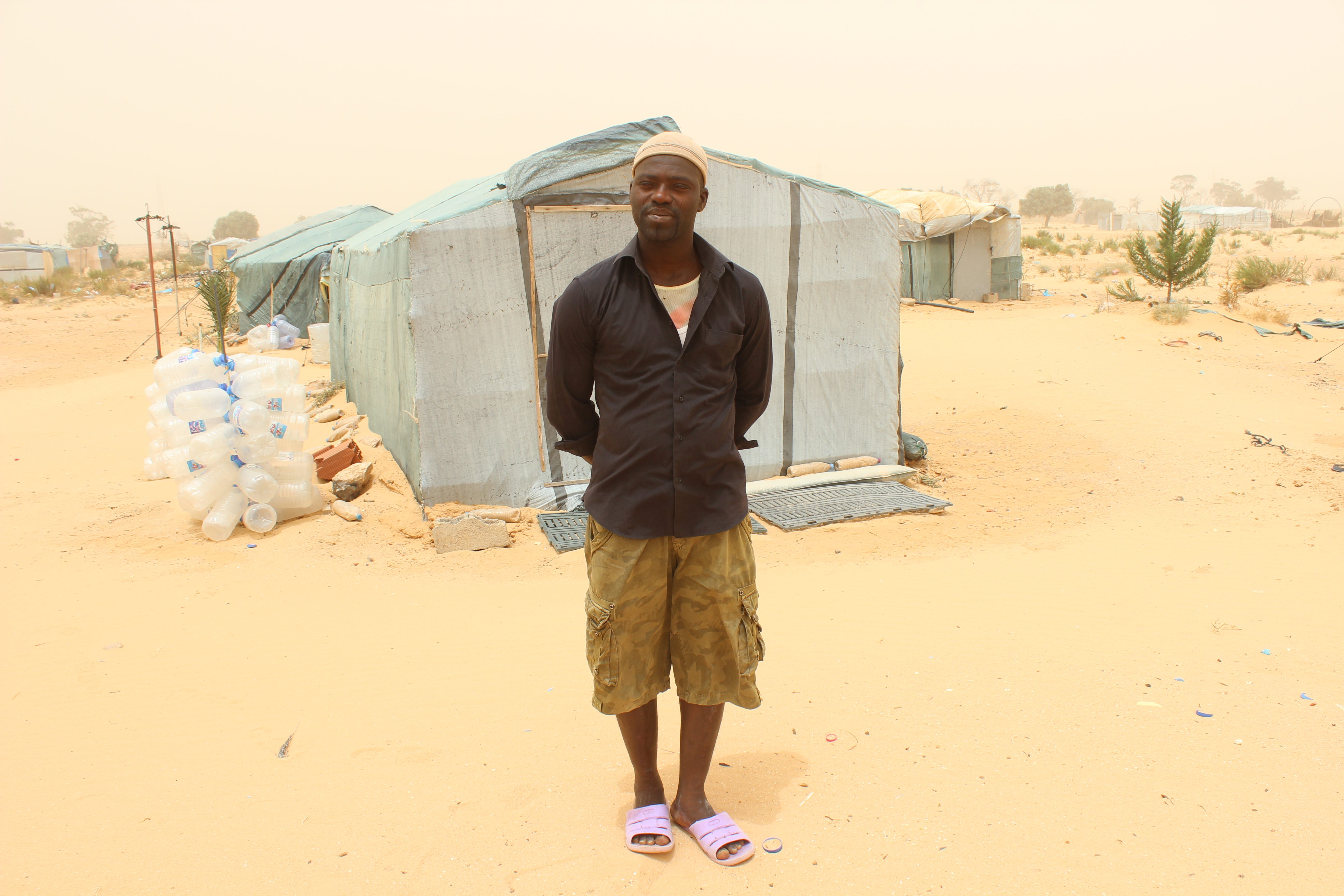Usman Bagura in front of his tent