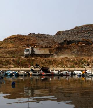 A truck hauls waste at the Bourj Hammoud landfill site. Untreated waste is being dumped into the sea as a part of the land reclamation project.
