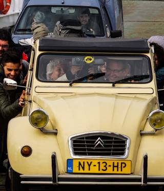 Keep pushing: Syrians help to get an old car started on a ferry across the river Meuse. 