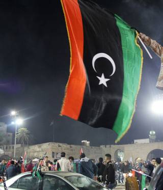 A militia man with a Libyan flag in downtown Tripoli. 